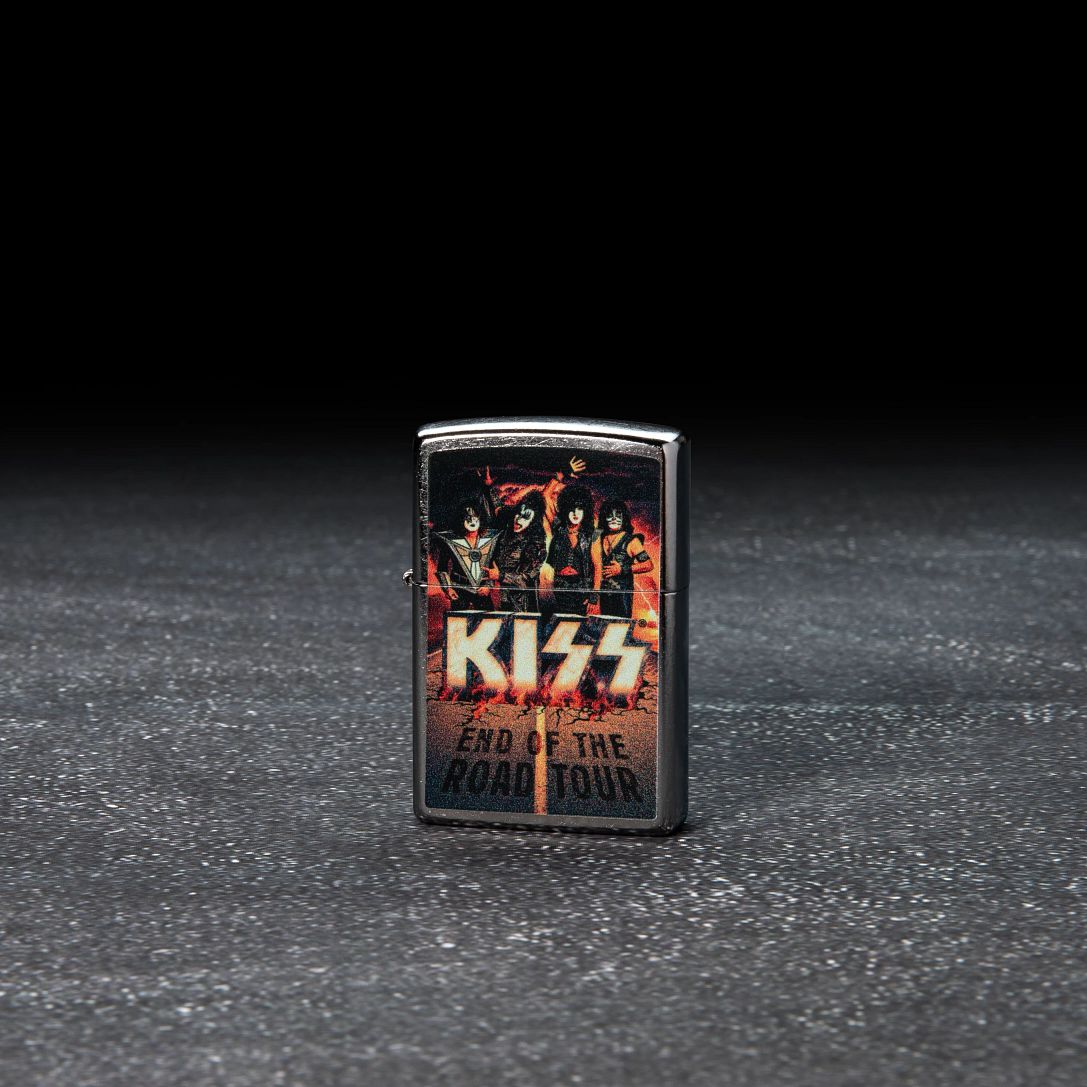 Lifestyle image of KISS Design End of the Road Tour Street Chrome?äó Windproof Lighter standing in a dark scene.