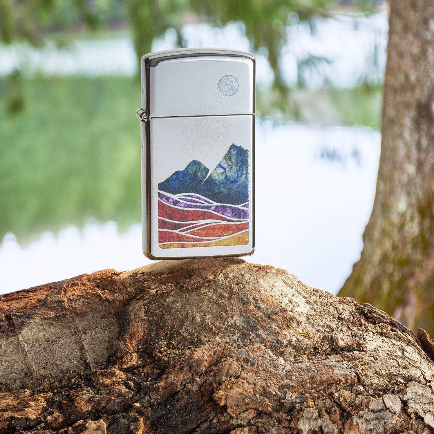 Lifestyle image of Slim?« Landscape Design High Polish Chrome Windproof Lighter standing on a log in a forest.