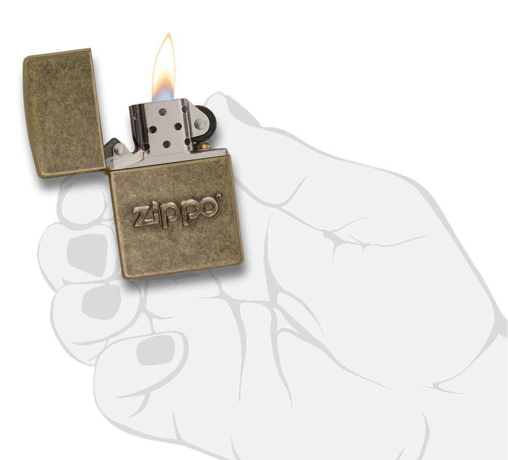 Zippo Stamp Antique Brass Lighter lit in hand