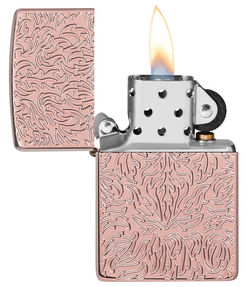 Zippo Carved Armor?« Rose Gold Design Windproof Lighter with its lid open and lit.