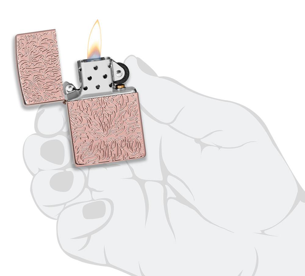 Zippo Carved Armor?« Rose Gold Design Windproof Lighter lit in hand.